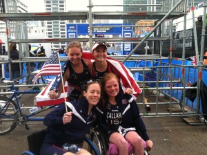 two girls in wheelchair, two girls standing. Holding American flag